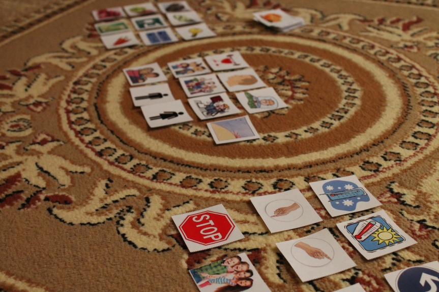 picture flashcards spread on ornamental rug
