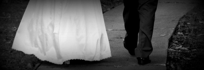 feet of bride and groom as they walk along a path