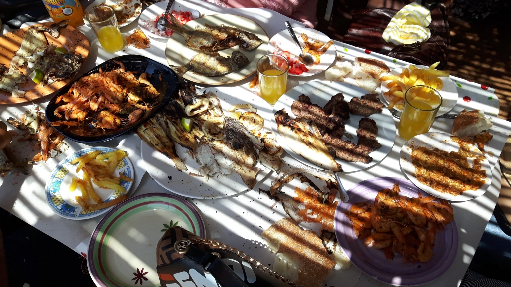 shaded table full of fried seafood