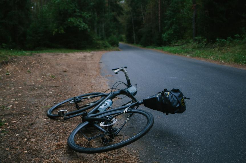 Bicycle laying on side of road